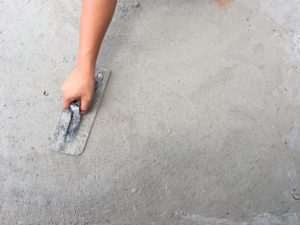 Person smoothing pavement