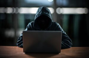 Identity fraudster on laptop