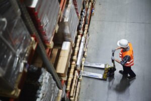 Man using machinery in warehouse
