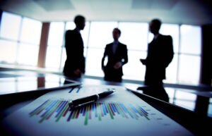 Three business people talking about financial information
