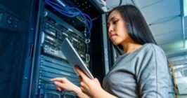 Woman in server room with tablet