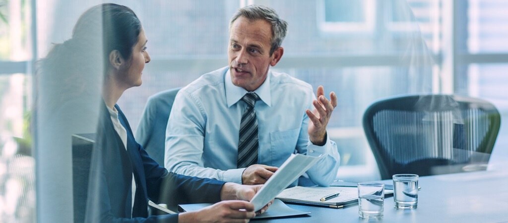 Business man and woman having a discussion in a meeting room