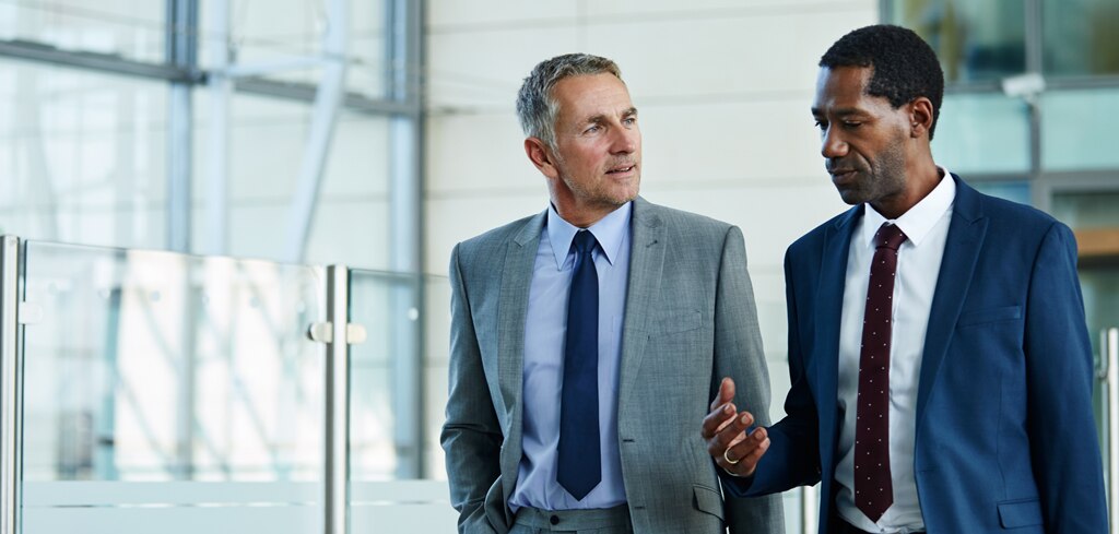 Two businessmen walking and talking