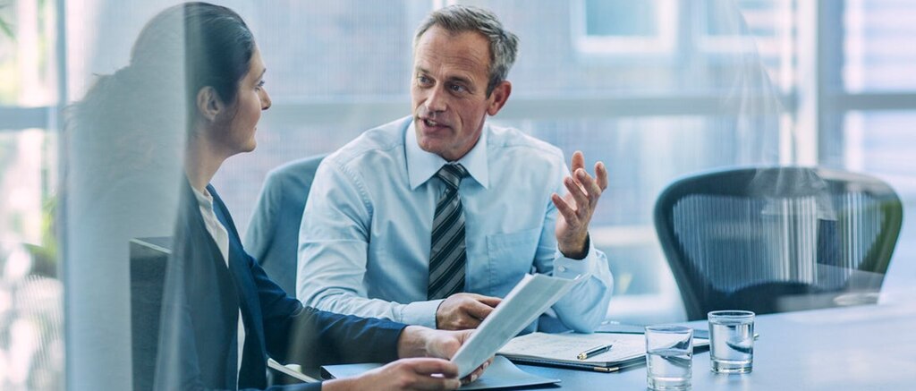 Man and woman talking in meeting room