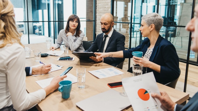 Group of business people in a boardroom having a meeting