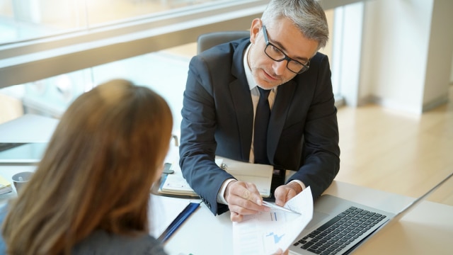 Businessman explaining financial information to someone