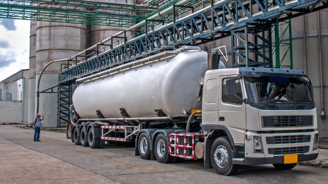Tanker truck being fueled at production facility
