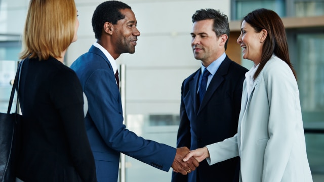 Business people standing and shaking hands