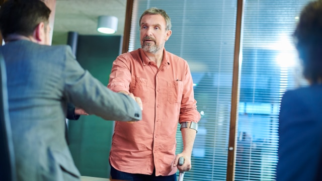 Two men shaking hands in an office